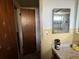 Bathroom with vanity, mirror, and damaged door at 12812 1St Isle, Hudson, FL 34667