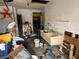 Interior of cluttered garage with sink and discarded items at 12812 1St Isle, Hudson, FL 34667