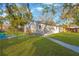 Spacious backyard with grassy lawn, wooden fence, and patio at 12918 Cambridge Ave, Tampa, FL 33624