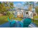 Relaxing backyard with patio and two teal chairs at 12918 Cambridge Ave, Tampa, FL 33624