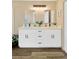 Double sink bathroom with white cabinets and quartz countertops at 12918 Cambridge Ave, Tampa, FL 33624