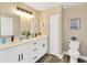 Double vanity bathroom with modern white cabinets and quartz countertops at 12918 Cambridge Ave, Tampa, FL 33624