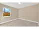Simple bedroom with neutral wall paint and carpet floors at 12918 Cambridge Ave, Tampa, FL 33624