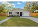 Newly renovated home with a landscaped lawn and modern facade at 12918 Cambridge Ave, Tampa, FL 33624