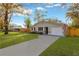 Newly renovated home with a spacious driveway and a well-maintained lawn at 12918 Cambridge Ave, Tampa, FL 33624