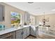 Eat-in kitchen with modern appliances and French doors to backyard at 12918 Cambridge Ave, Tampa, FL 33624