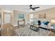 Bright living room featuring a comfy sofa, stylish rug, and wood-look flooring at 12918 Cambridge Ave, Tampa, FL 33624