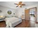 Bedroom with wood floors, a large window and en-suite bathroom at 1322 Pelican Creek Xing # C, St Petersburg, FL 33707