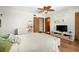 Bedroom with wood floors, ceiling fan and en-suite bathroom at 1322 Pelican Creek Xing # C, St Petersburg, FL 33707