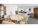 Hexagonal dining table with four chairs situated near the kitchen at 1322 Pelican Creek Xing # C, St Petersburg, FL 33707