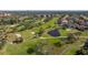 Aerial view of a golf course with pond and residential area at 1322 Pelican Creek Xing # C, St Petersburg, FL 33707