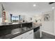 Kitchen with granite countertops and view into living area at 1322 Pelican Creek Xing # C, St Petersburg, FL 33707