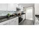 Modern kitchen with stainless steel appliances and granite countertops at 1322 Pelican Creek Xing # C, St Petersburg, FL 33707