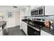 Modern kitchen with stainless steel appliances and granite countertops at 1322 Pelican Creek Xing # C, St Petersburg, FL 33707