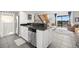 Modern kitchen with white cabinets, stainless steel appliances, and a breakfast bar at 1322 Pelican Creek Xing # C, St Petersburg, FL 33707