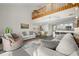 Open living area with a lofted ceiling, comfy seating, and a view of the kitchen at 1322 Pelican Creek Xing # C, St Petersburg, FL 33707