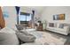 Living room with comfy seating, large window, and view of a lake at 1322 Pelican Creek Xing # C, St Petersburg, FL 33707