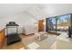 Bright loft area with vaulted ceiling, treadmill, and access to balcony at 1322 Pelican Creek Xing # C, St Petersburg, FL 33707