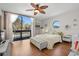 Primary bedroom with a view, wood floors, and access to a balcony at 1322 Pelican Creek Xing # C, St Petersburg, FL 33707