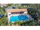 Community pool with surrounding lounge chairs at 1322 Pelican Creek Xing # C, St Petersburg, FL 33707