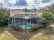 House with a pool and fenced-in backyard, surrounded by lush landscaping at 13315 Carnoustie Cir, Dade City, FL 33525