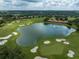 Community overview showcasing a pond, golf course, and houses at 13315 Carnoustie Cir, Dade City, FL 33525
