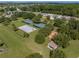 Community overview featuring courts, playground, and green space at 13315 Carnoustie Cir, Dade City, FL 33525