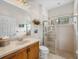 Bathroom boasts a walk-in shower and wood vanity at 13315 Carnoustie Cir, Dade City, FL 33525