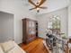 Bright bedroom with hardwood floors, a large armoire, and a drum set at 13315 Carnoustie Cir, Dade City, FL 33525