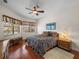 Main bedroom with king-size bed, hardwood floors, and dresser at 13315 Carnoustie Cir, Dade City, FL 33525