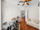 Bedroom with hardwood floors, a comfy couch, and access to another room at 13315 Carnoustie Cir, Dade City, FL 33525