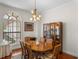 Formal dining room with wood table, chairs, and a large window at 13315 Carnoustie Cir, Dade City, FL 33525