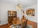 Elegant dining room featuring a wood table and built-in hutch at 13315 Carnoustie Cir, Dade City, FL 33525