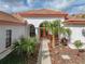 Elegant entryway with double doors and palm trees at 13315 Carnoustie Cir, Dade City, FL 33525