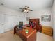 Spacious home office with built-in shelving and a large desk at 13315 Carnoustie Cir, Dade City, FL 33525