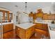 Well-equipped kitchen with wood cabinets, large island, and breakfast bar at 13315 Carnoustie Cir, Dade City, FL 33525