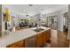 Kitchen with island, stainless steel appliances and views to Gathering room at 13315 Carnoustie Cir, Dade City, FL 33525