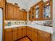 Kitchen with wood cabinets, glass-front upper cabinets, and white countertops at 13315 Carnoustie Cir, Dade City, FL 33525