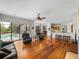 Open living space with hardwood floors, pool access, and kitchen views at 13315 Carnoustie Cir, Dade City, FL 33525