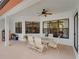 Spacious covered patio with table and chairs, perfect for outdoor dining at 13315 Carnoustie Cir, Dade City, FL 33525