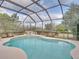 Inviting screened pool and spa with open view at 13315 Carnoustie Cir, Dade City, FL 33525