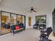 Spacious screened porch with wicker furniture at 13315 Carnoustie Cir, Dade City, FL 33525