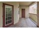 Balcony with two doors and a wooden deck at 1429 Villa Capri Cir # 306, Odessa, FL 33556