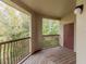 Wooden balcony with storage and views of lush trees at 1429 Villa Capri Cir # 306, Odessa, FL 33556
