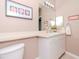 Clean bathroom with white vanity, toilet and a framed picture at 1429 Villa Capri Cir # 306, Odessa, FL 33556