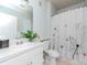 Clean bathroom with shower/tub combo, white vanity, and floral shower curtain at 1429 Villa Capri Cir # 306, Odessa, FL 33556