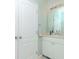 Small bathroom with white vanity, mirror, and linen closet at 1429 Villa Capri Cir # 306, Odessa, FL 33556