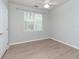 Simple bedroom with neutral walls, ceiling fan, and wood-look flooring at 1429 Villa Capri Cir # 306, Odessa, FL 33556