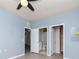 Light blue bedroom with wood-look floors and ensuite bathroom at 1429 Villa Capri Cir # 306, Odessa, FL 33556