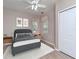 Main bedroom with a gray bed, wooden nightstands, and a ceiling fan at 1429 Villa Capri Cir # 306, Odessa, FL 33556